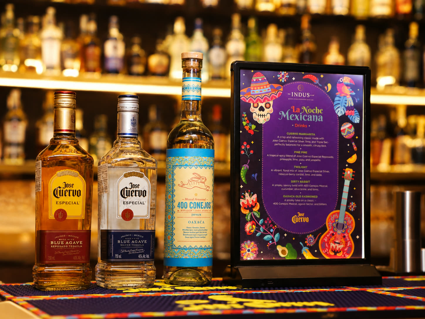 Jose Cuervo and mezcal bottles styled with the La Noche Mexicana drinks menu