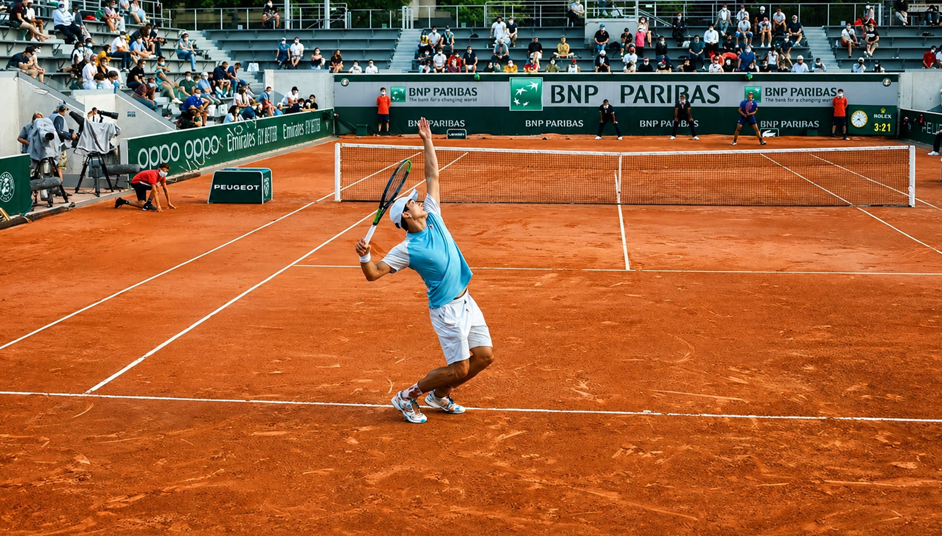 A player serving on the clay court at the French Open